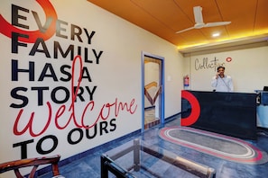 A reception area with a large wall sign that reads 'EVERY FAMILY HAS A STORY Welcome to Ours'. - Super Collection O Kalinga Bapuji Nagar (Bhubaneswar)