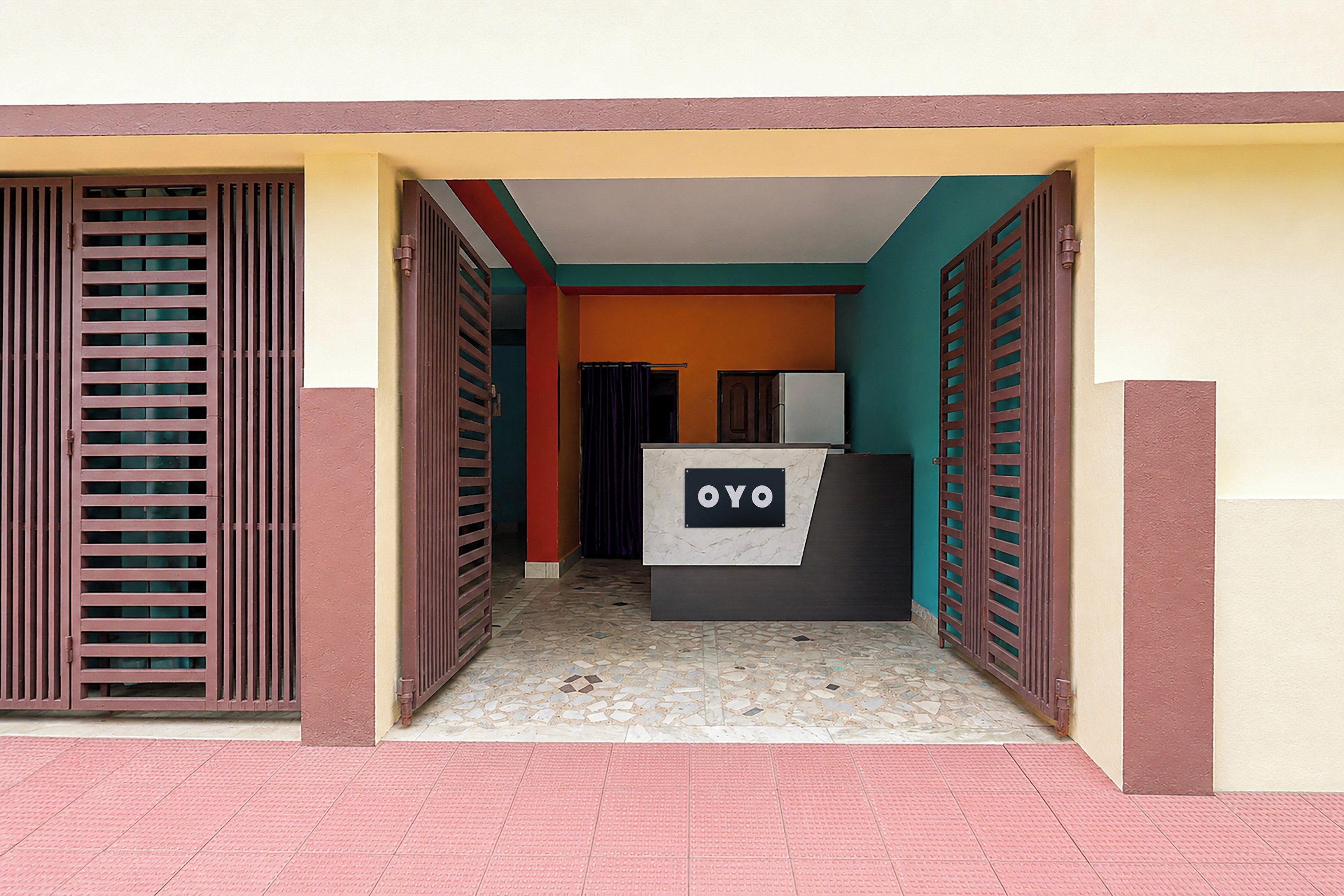 A reception area with a sign reading 'OYO' and a tiled floor.