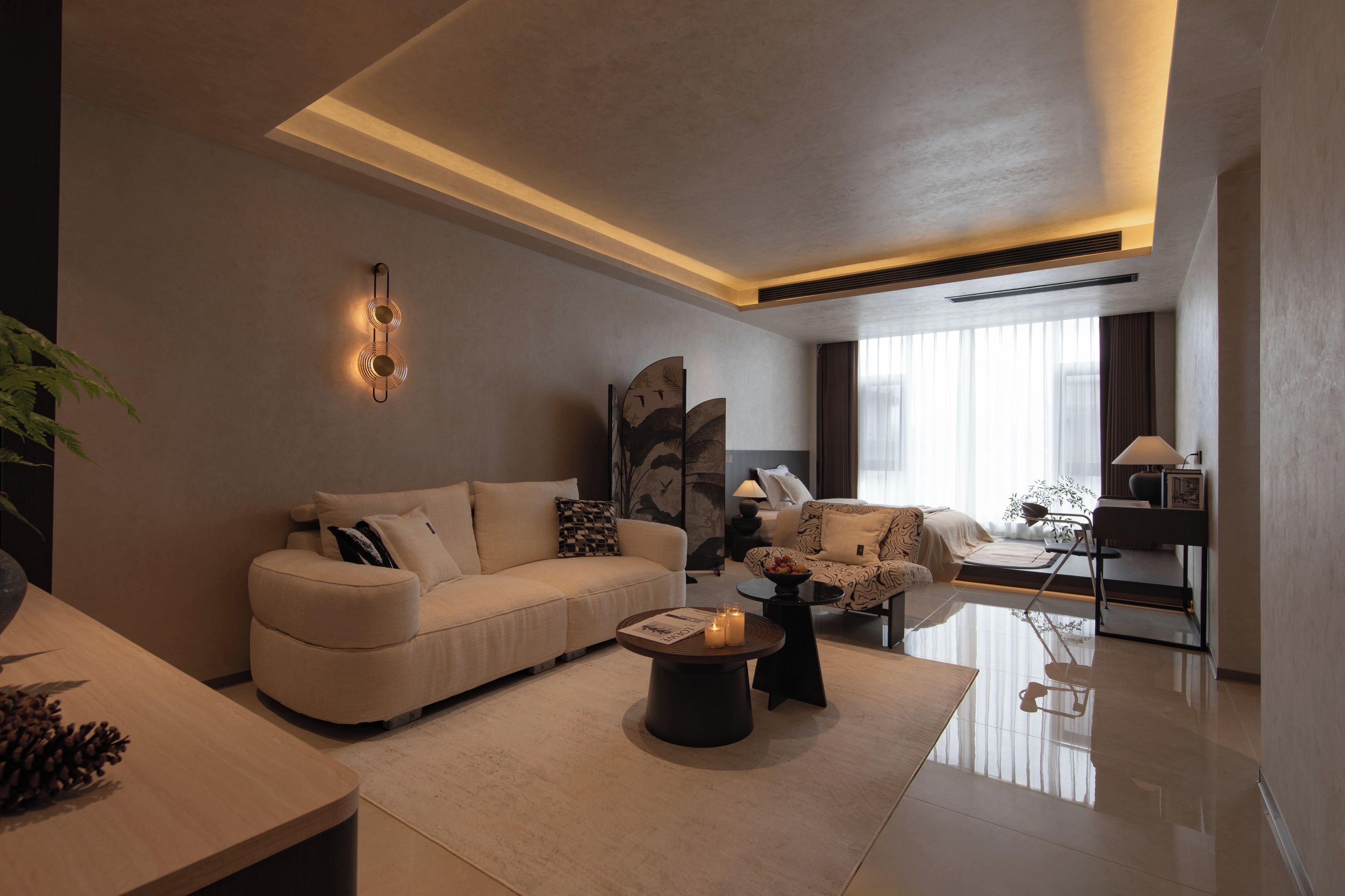 A modern living room with a sofa, a coffee table, and a lamp.