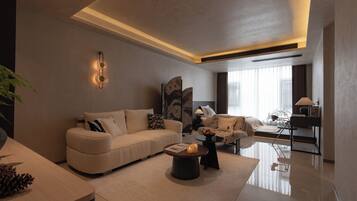 A modern living room with a sofa, a coffee table, and a lamp.