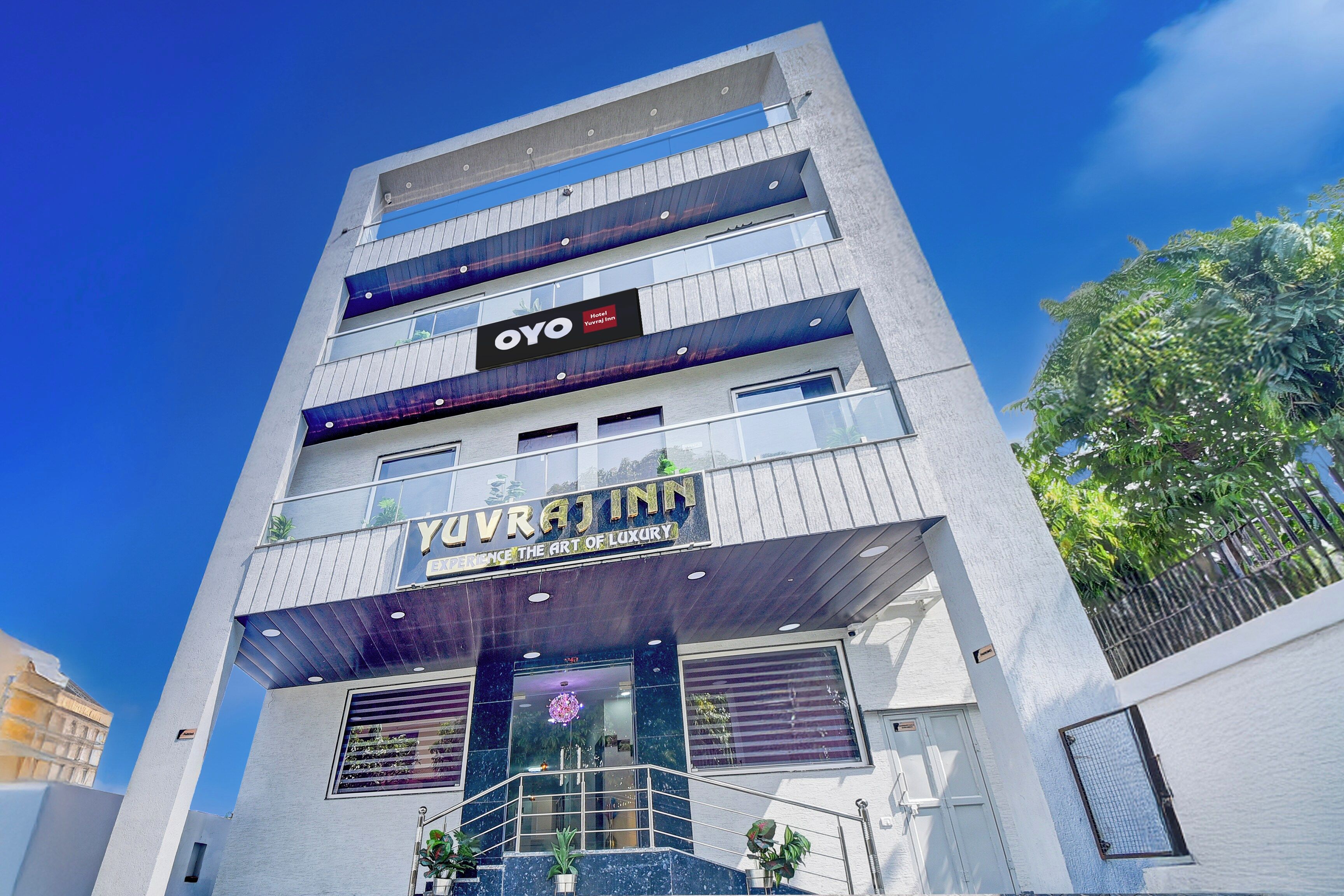 A multi-story hotel with a modern design, featuring balconies and a prominent entrance.