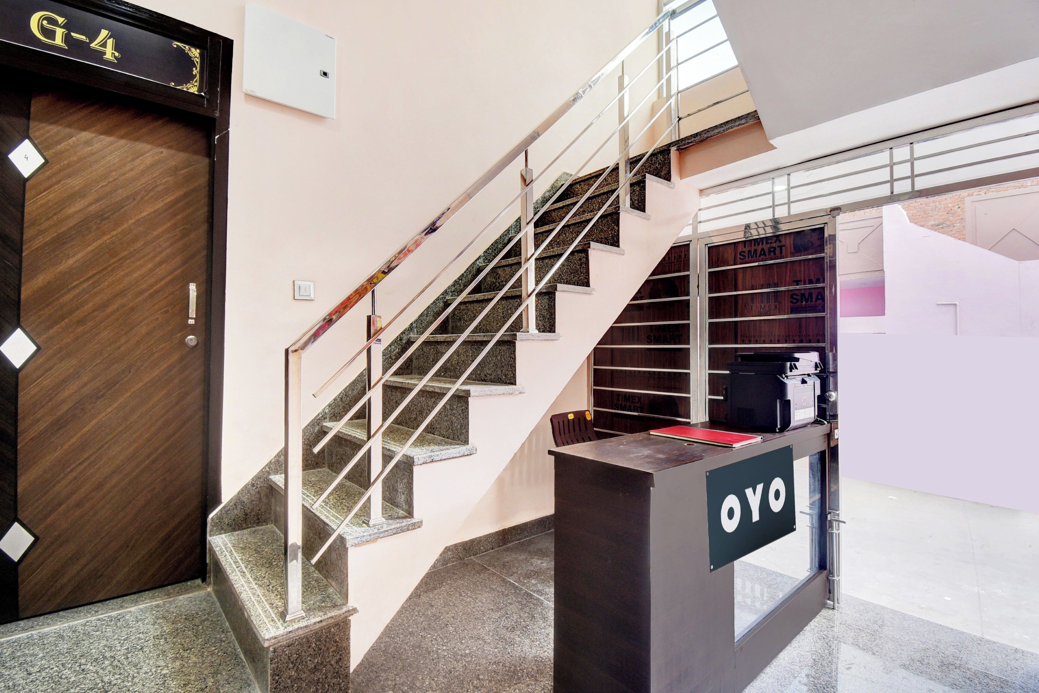 A staircase with metal railings and a wooden door labeled 'G-4'.