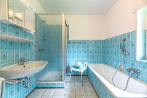 Ein Badezimmer mit Dusche, Waschbecken und Badewanne.