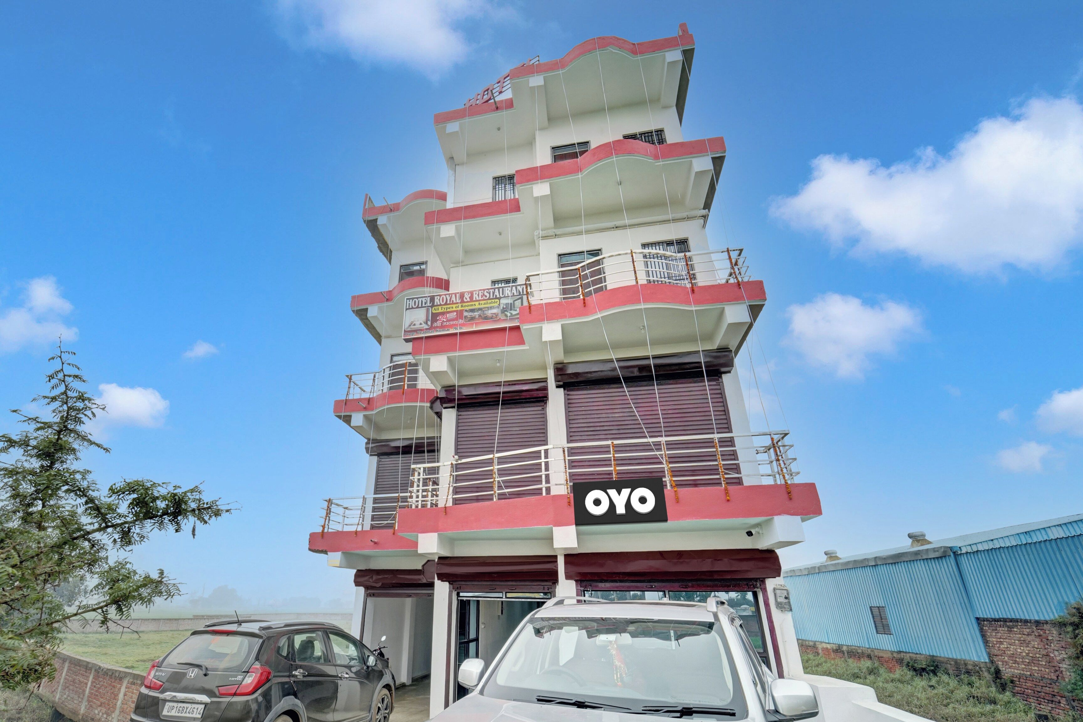 A multi-story hotel building with balconies and a sign indicating it is a hotel and restaurant.