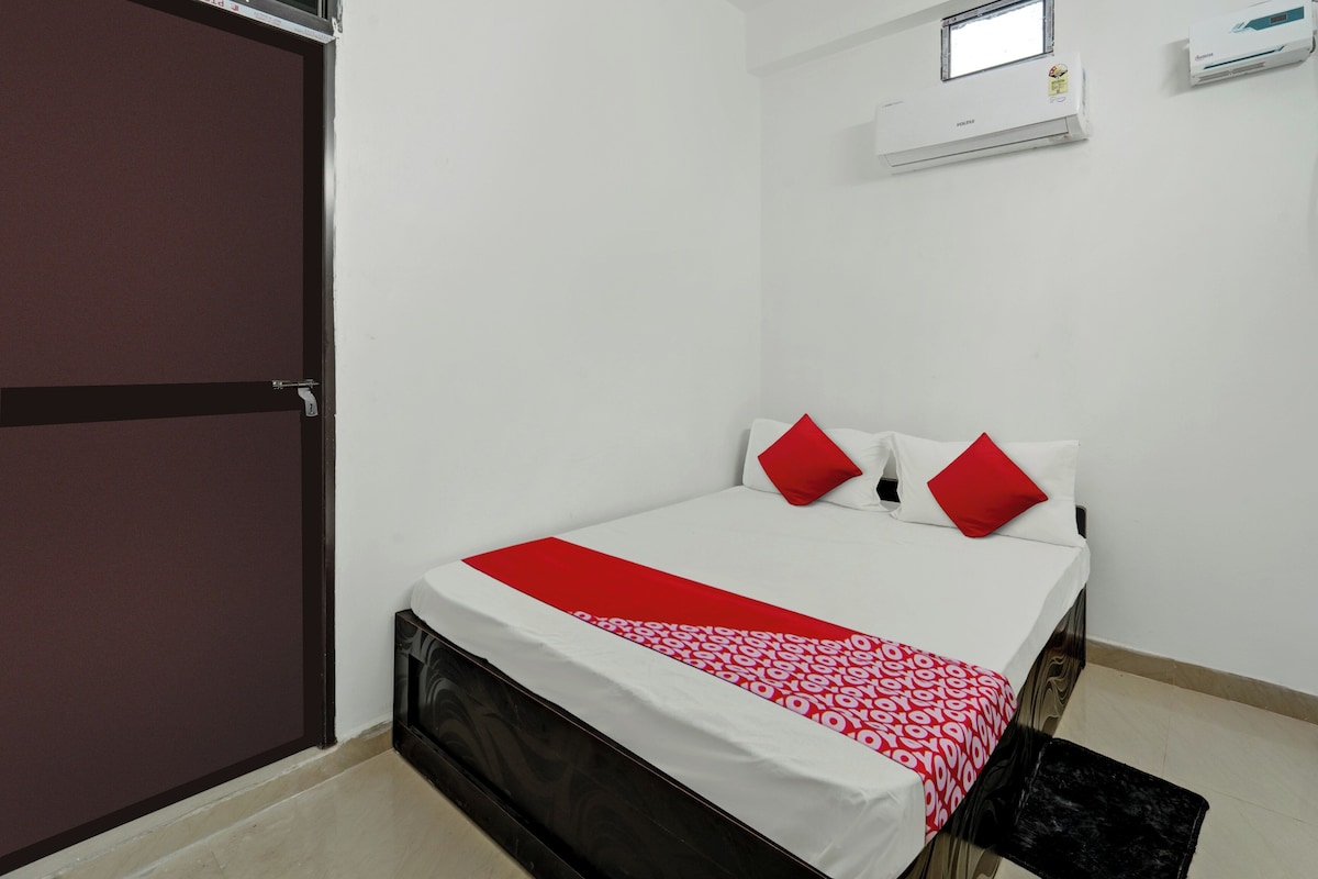 Une chambre à coucher avec un lit, une fenêtre et un appareil de climatisation.