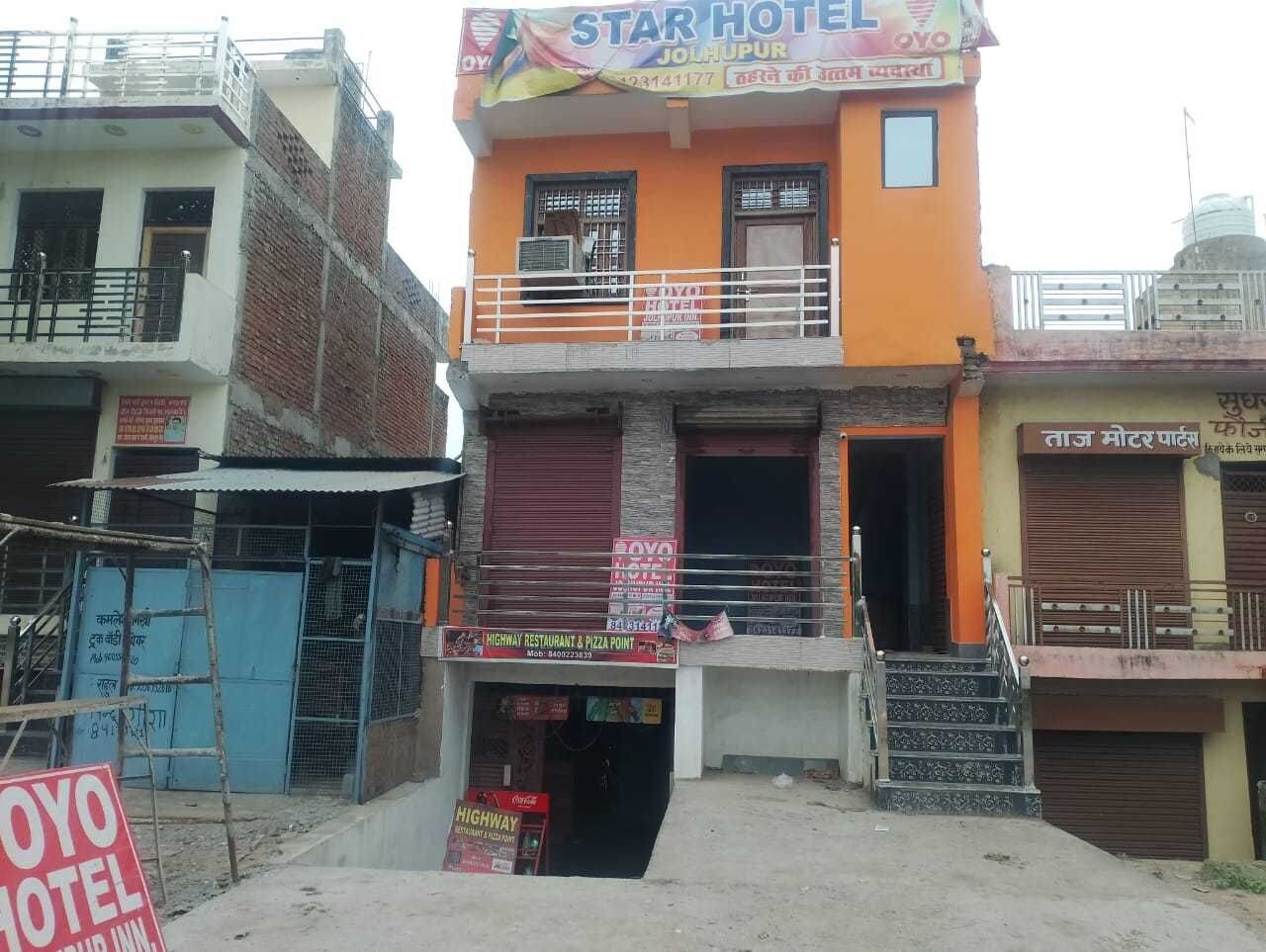 A hotel with a signboard for 'Star Hotel' and a 'Highway Restaurant & Pizza Point' below.