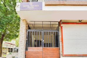 A hotel entrance with a sign indicating 'HOTEL GOLDEN PEARL' and a gated entrance. - Hotel O Golden Pearl (Bhopal)