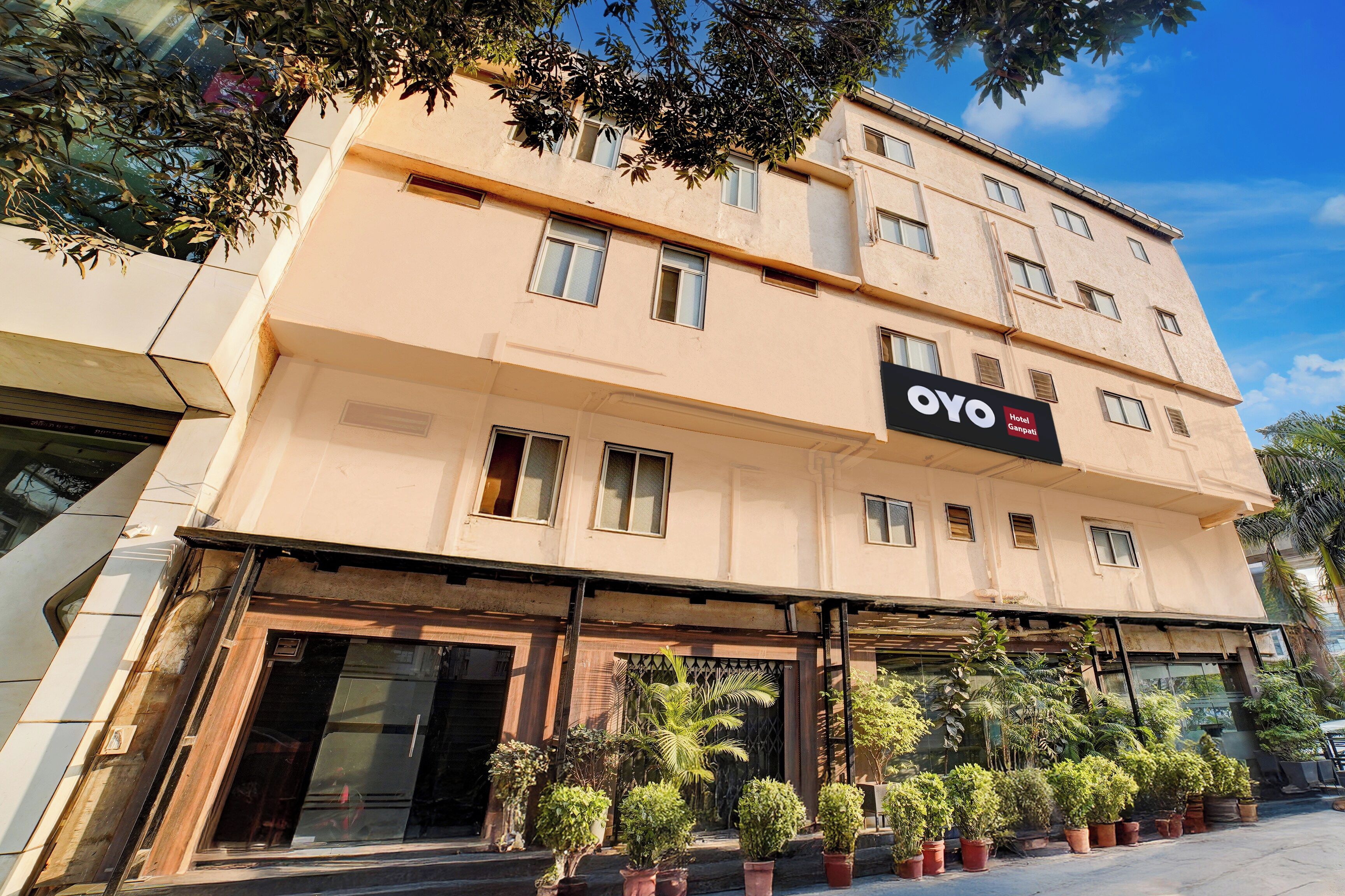 Un edificio de hotel con varias ventanas y un letrero que dice 'OYO Hotel Ganpati'.
