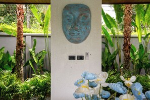 A wall-mounted sculpture with a textured surface and electrical outlets.