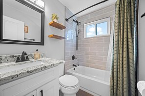 Bright bathroom with a shower/tub combination and modern fixtures. - Cozy Retreat Near Sloan's Lake (Denver)