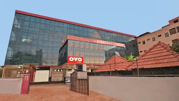 A modern building with a glass facade and a red roof.