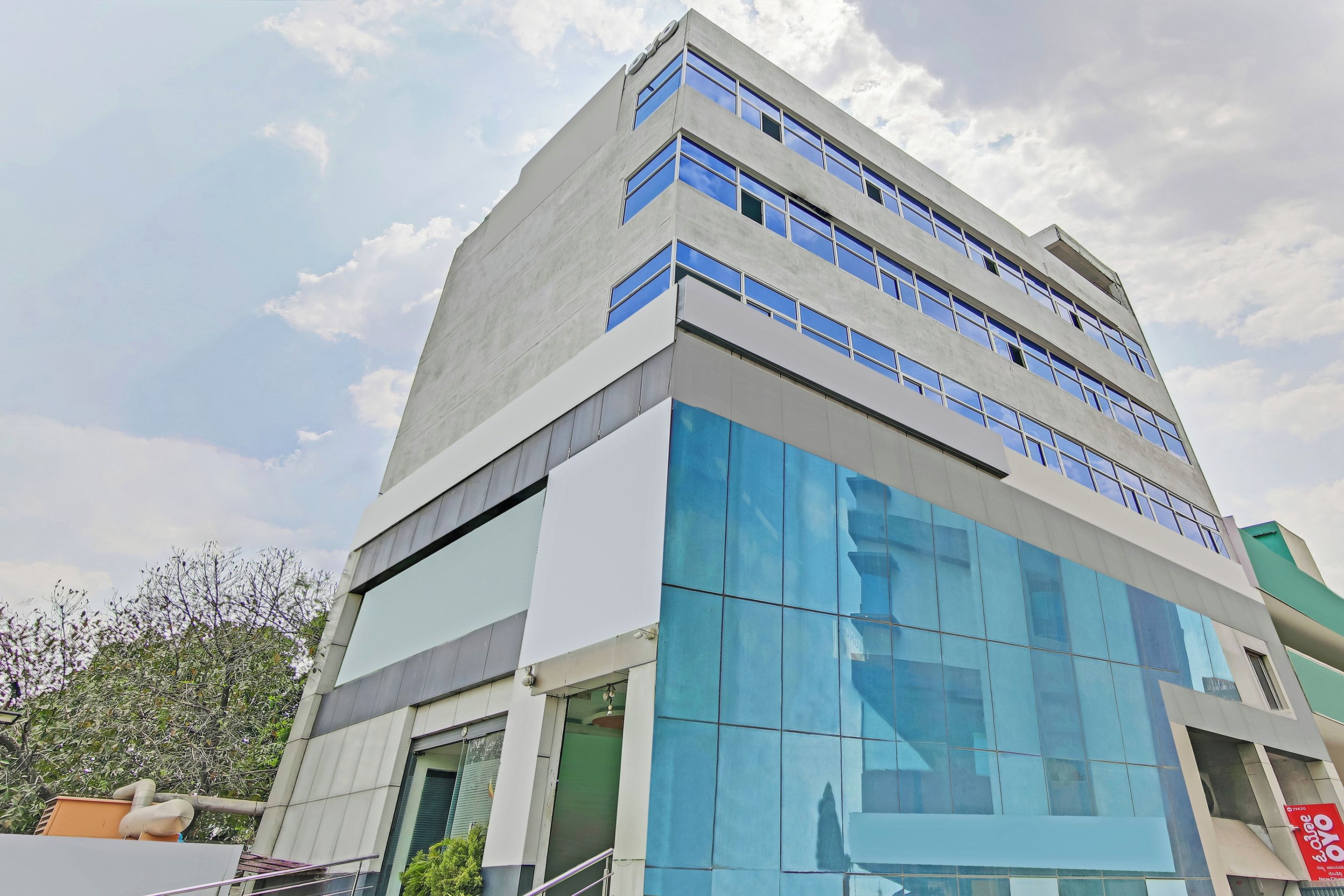 A modern building with a glass facade and multiple floors.