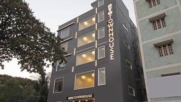 A multi-story building with a sign reading 'OYOTOWNHOUSE'.