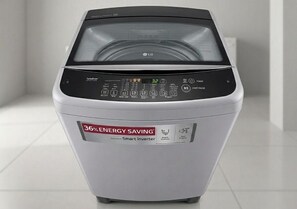 A front view of a white washing machine with a digital display and control panel. - Moorish Mount Queen Retreat – Cool Hilltop Room, Mandeville (Mandeville)