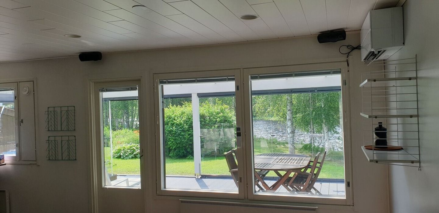 Une pièce dotée d’une porte-fenêtre coulissante donnant sur un patio avec une table et des chaises.