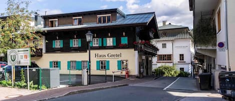 A traditional wooden building with a sign 'Haus Gretel' indicating a hotel.