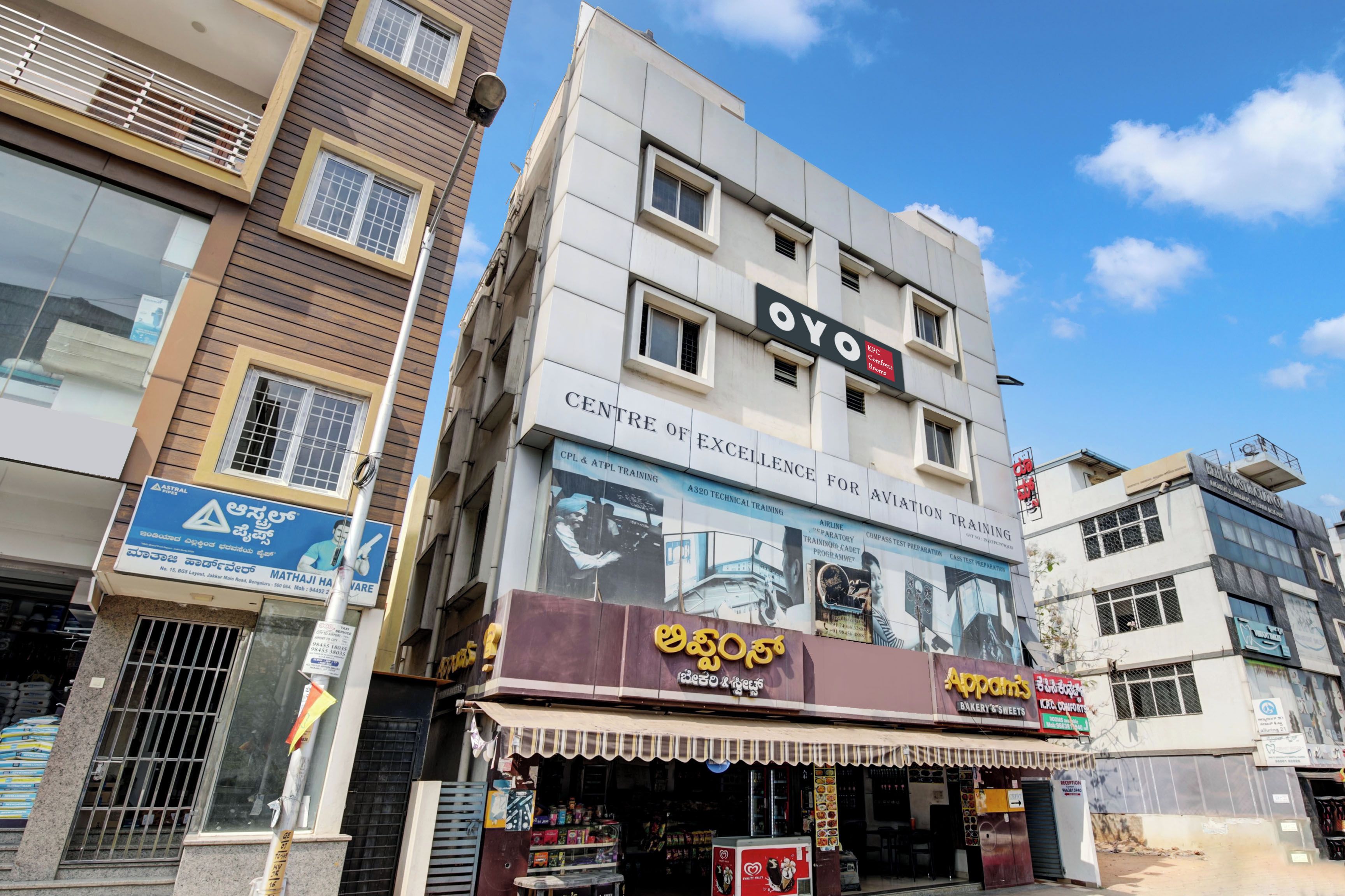 A multi-story building with signage for 'OYO' and 'KFC Comfort Rooms'.