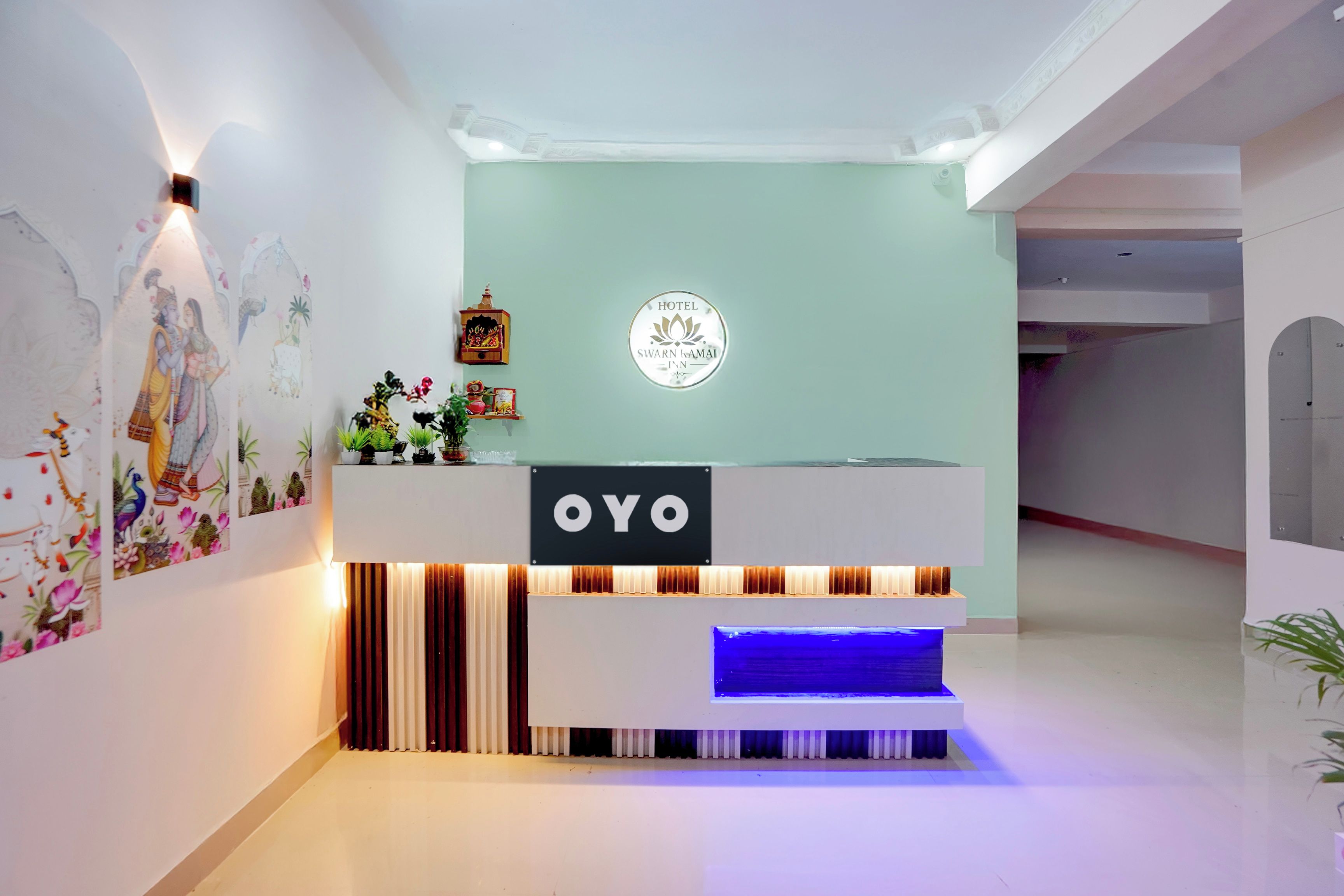 A reception desk with a sign that reads 'OYO' and a logo above it.