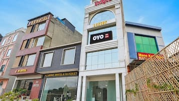 A row of hotels with signage indicating names and services.
