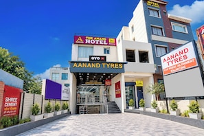 A hotel entrance with multiple signs for 'The Anand Hotel' and 'A Anand Tyres'. - Hotel O The Anand Hotel (Zirakpur)