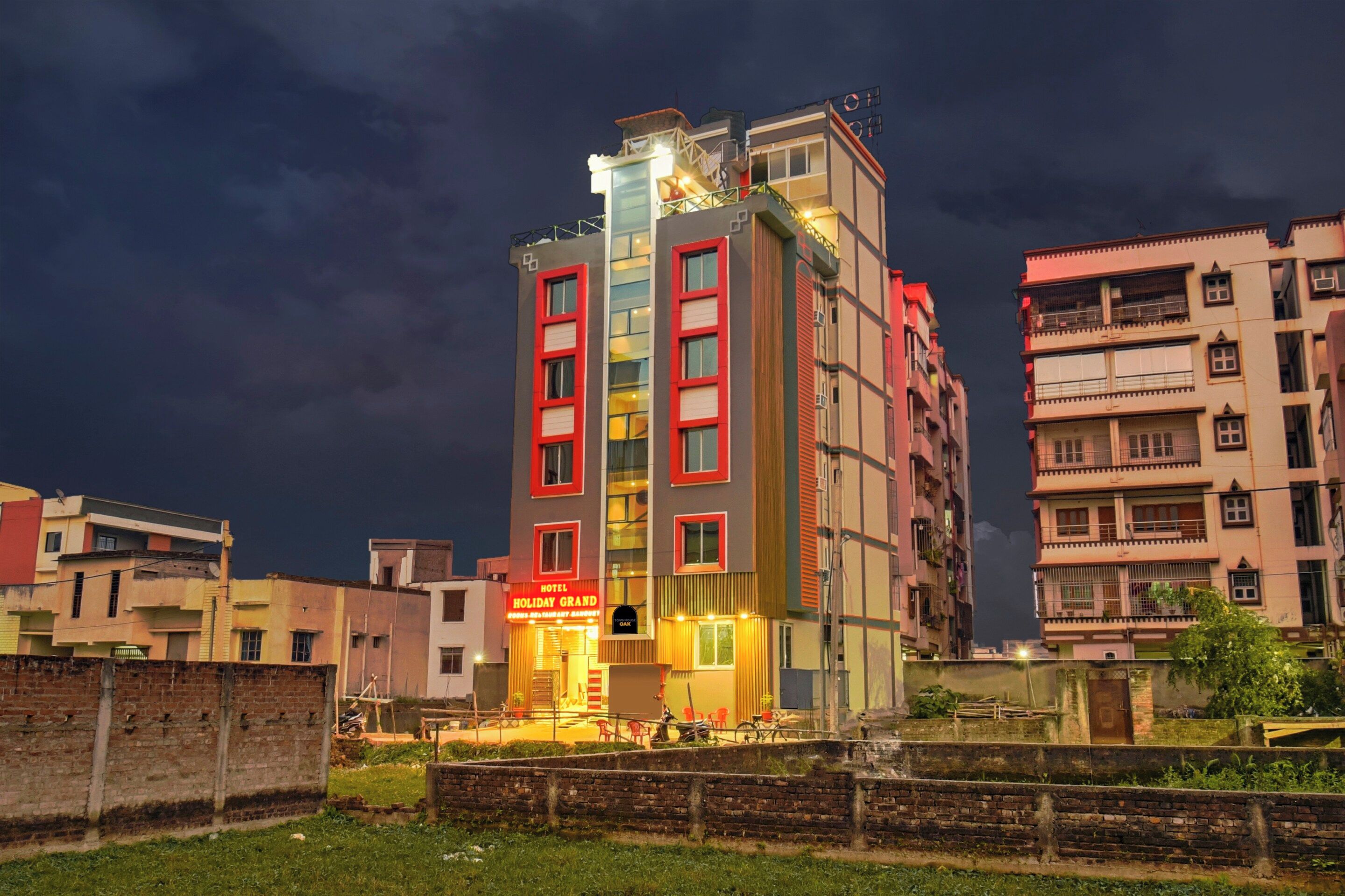 A multi-story hotel with a prominent sign for 'Holiday Grand.'