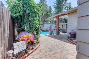 A pathway leading to a pool area with a sign indicating the direction to the last door on the right.