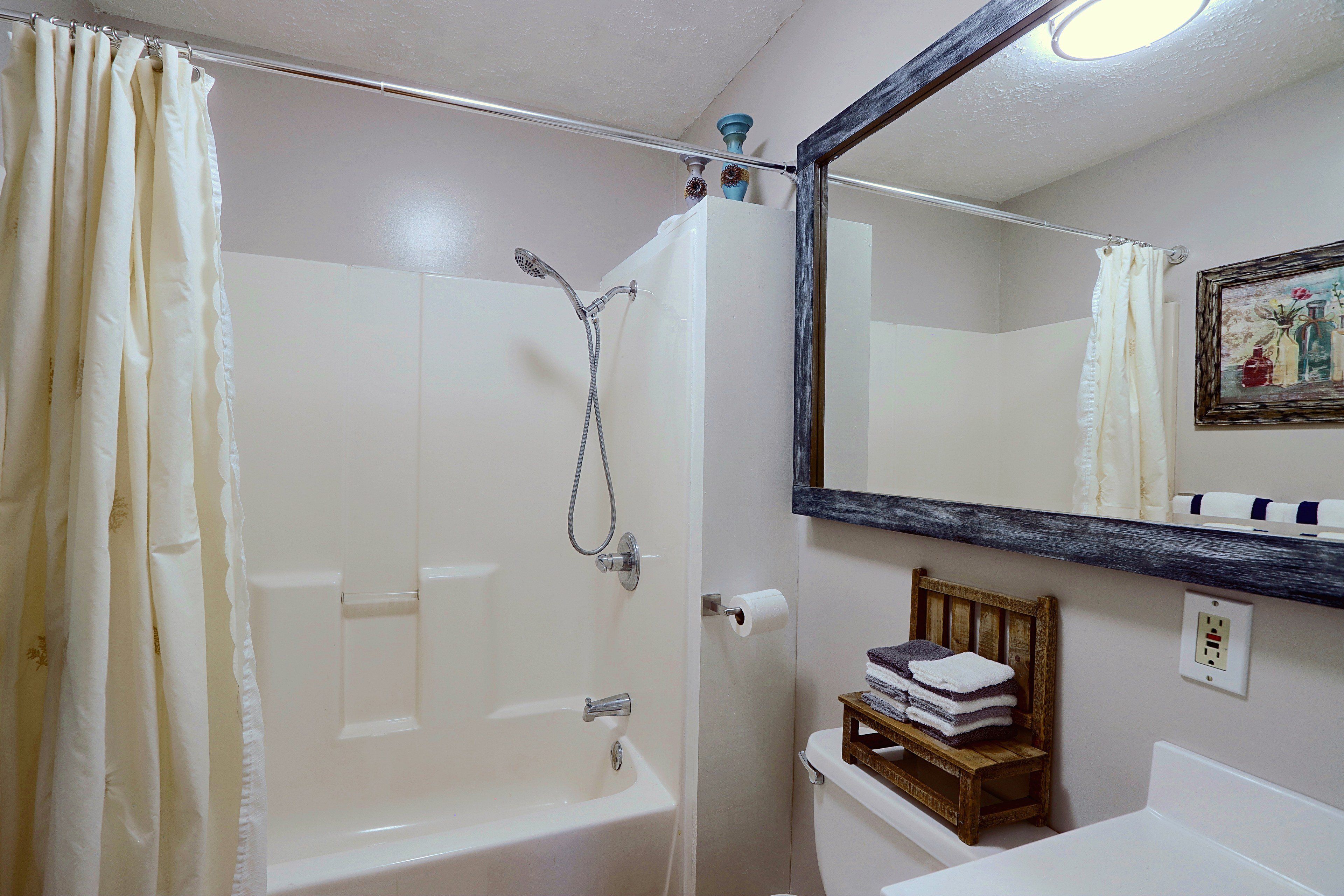 A bathroom with a shower, toilet, and sink.
