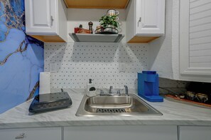 A kitchen with a stainless steel sink, a coffee machine, and a bottle of hand soap. - Briza Azul Studio Apartment 3 Mi to Weeki Wache (Spring Hill)