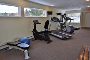 A gym with treadmills, an elliptical, and a stationary bike. - Trout Creek 13 | Pools, Hot Tub, Great Location! (Harbor Springs)