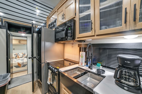 A compact kitchenette with a microwave, coffee maker, and a small sink. - 1 Mi to Kentucky Lake! 'special Place' Tiny Home (Springville)
