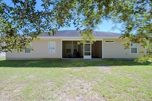 A single-story house with a front porch, a garage, and a small front yard.
