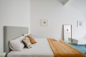 A modern hotel room with a bed, a desk, and a mirror. - NEW! Rooftop Charm Lisbon Retreat (Lisbon)