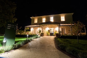 A two-story building with a covered entrance and a pathway leading to the door. - *NEW* Large Luxury Garden Terrace Suite in South Downs (Warningcamp)