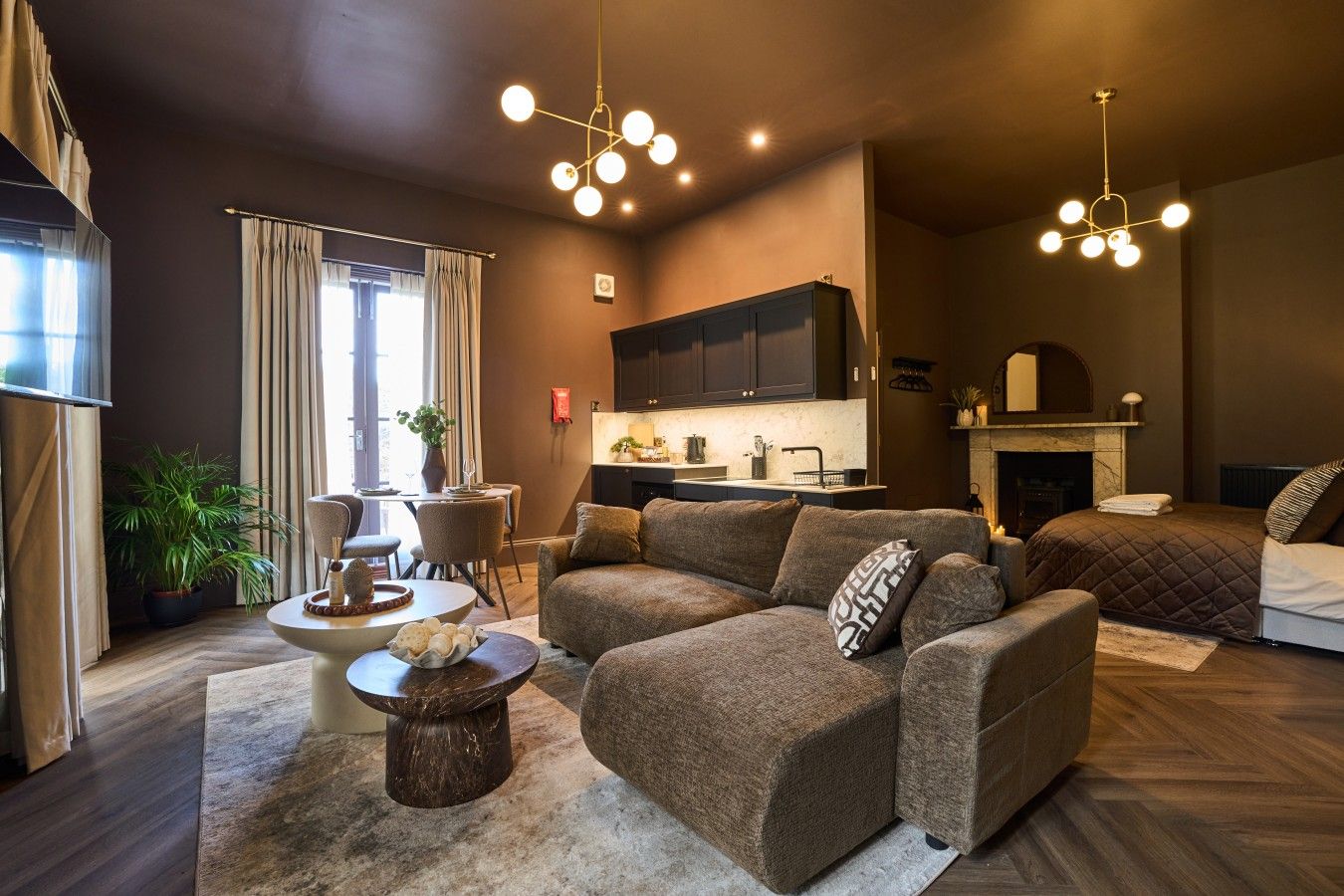A modern living room with a sofa, a coffee table, and a fireplace.