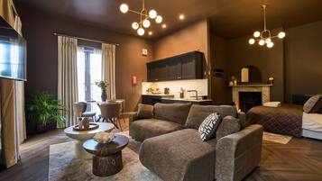 A modern living room with a sofa, a coffee table, and a fireplace.