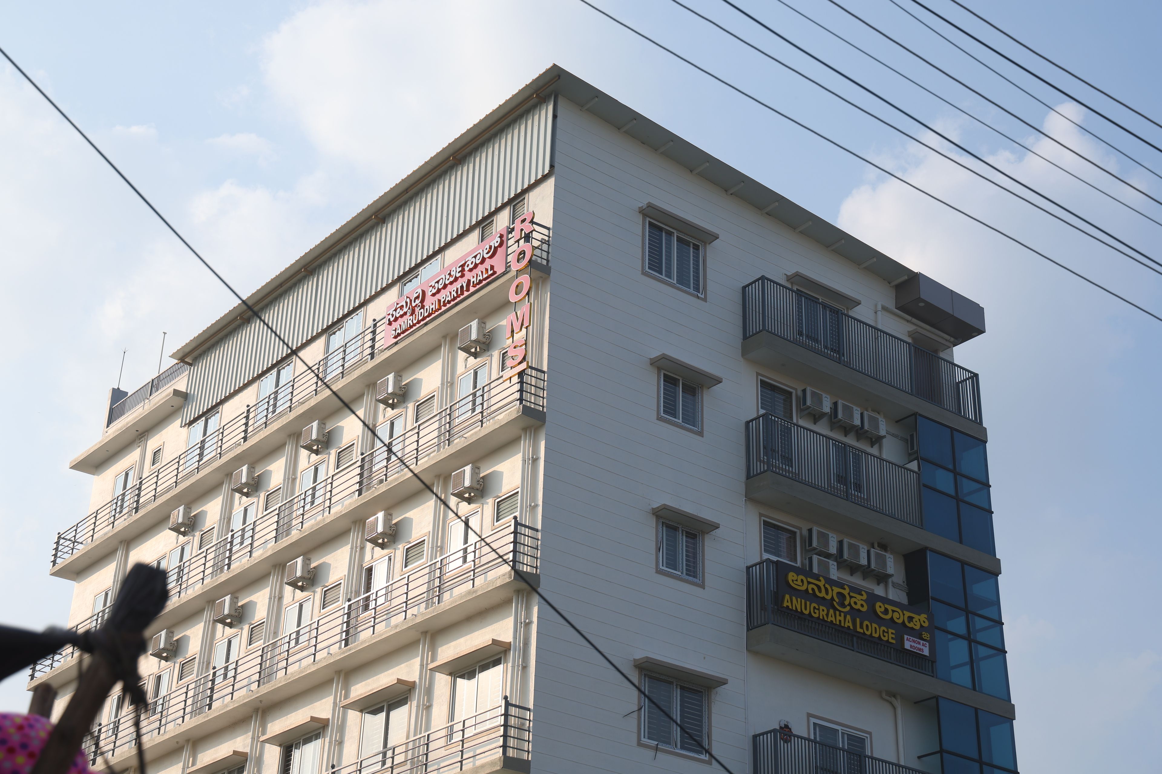 A multi-story building with balconies and air conditioning units.