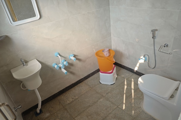 A bathroom with a toilet, sink, and shower.