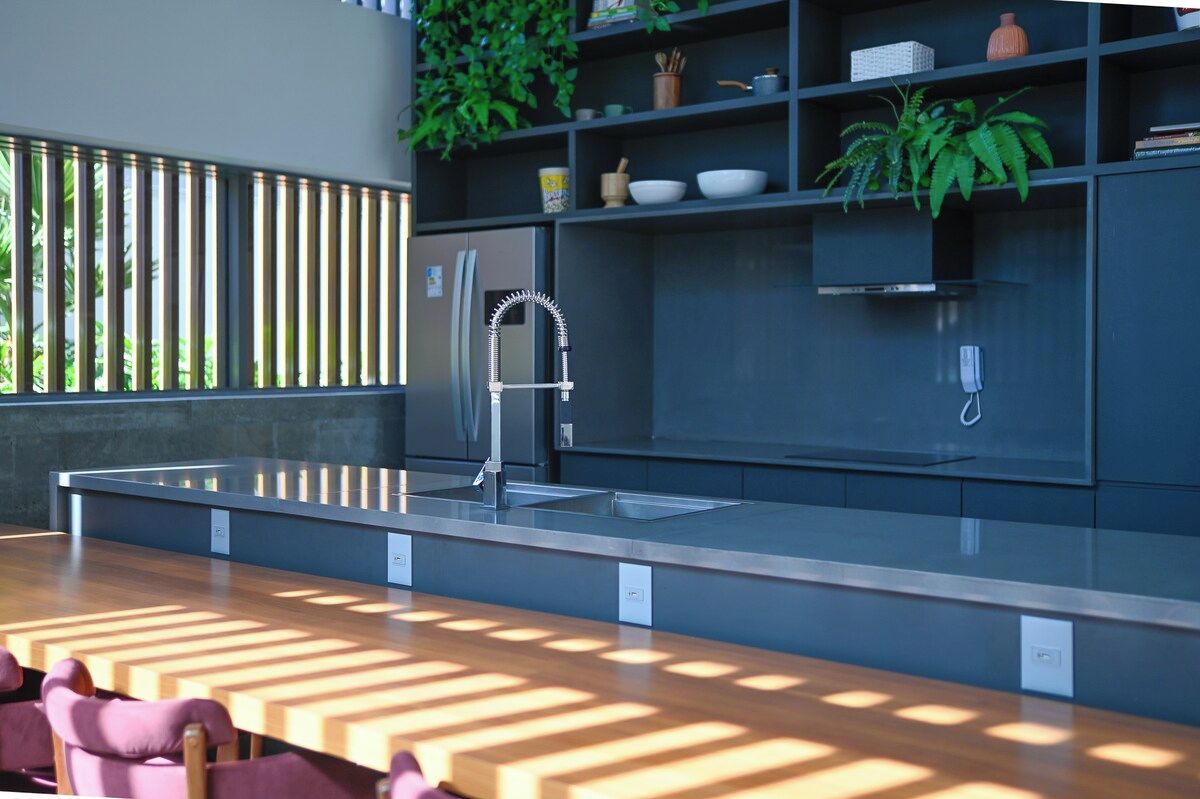 A modern kitchen with a built-in sink, a stainless steel faucet, and a countertop.