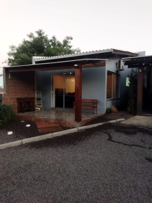 A modern house with a patio, a brick fireplace, and a covered outdoor area. - New Listing (Vera Cruz)