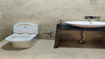 A bathroom with a toilet and a sink.