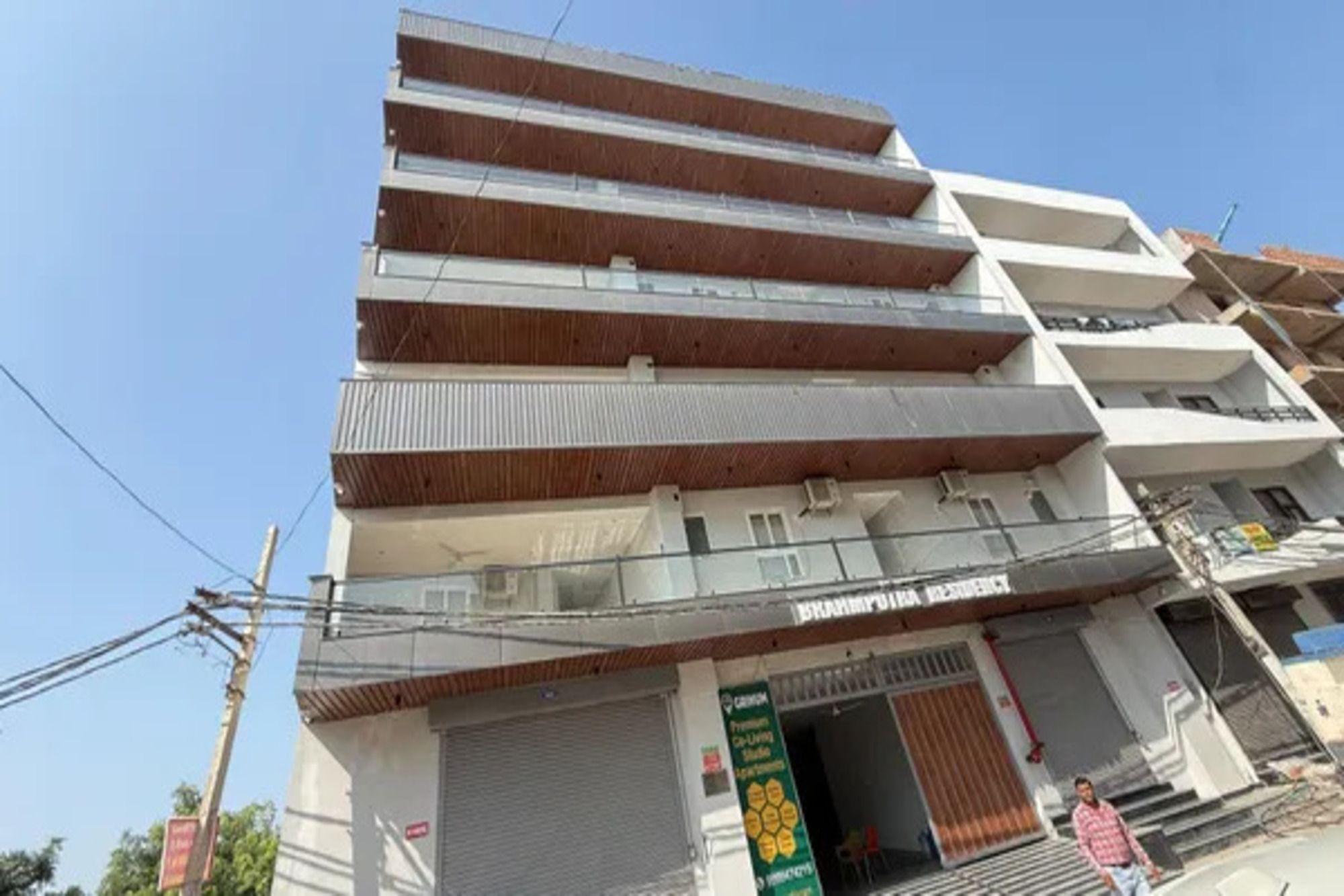 A multi-story building with a commercial ground floor, featuring a storefront with a sign that reads 'BHAYAPUR VISION'.
