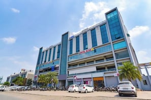 A multi-story hotel with a prominent sign for 'HOTEL BLISS'. - FabHotel Bliss (Ahmedabad)
