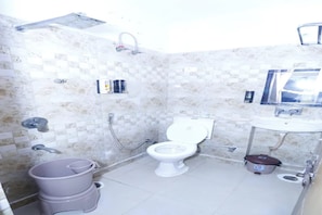 A bathroom with a toilet, sink, and shower. - FabHotel Skyline Residency (Ghaziabad)