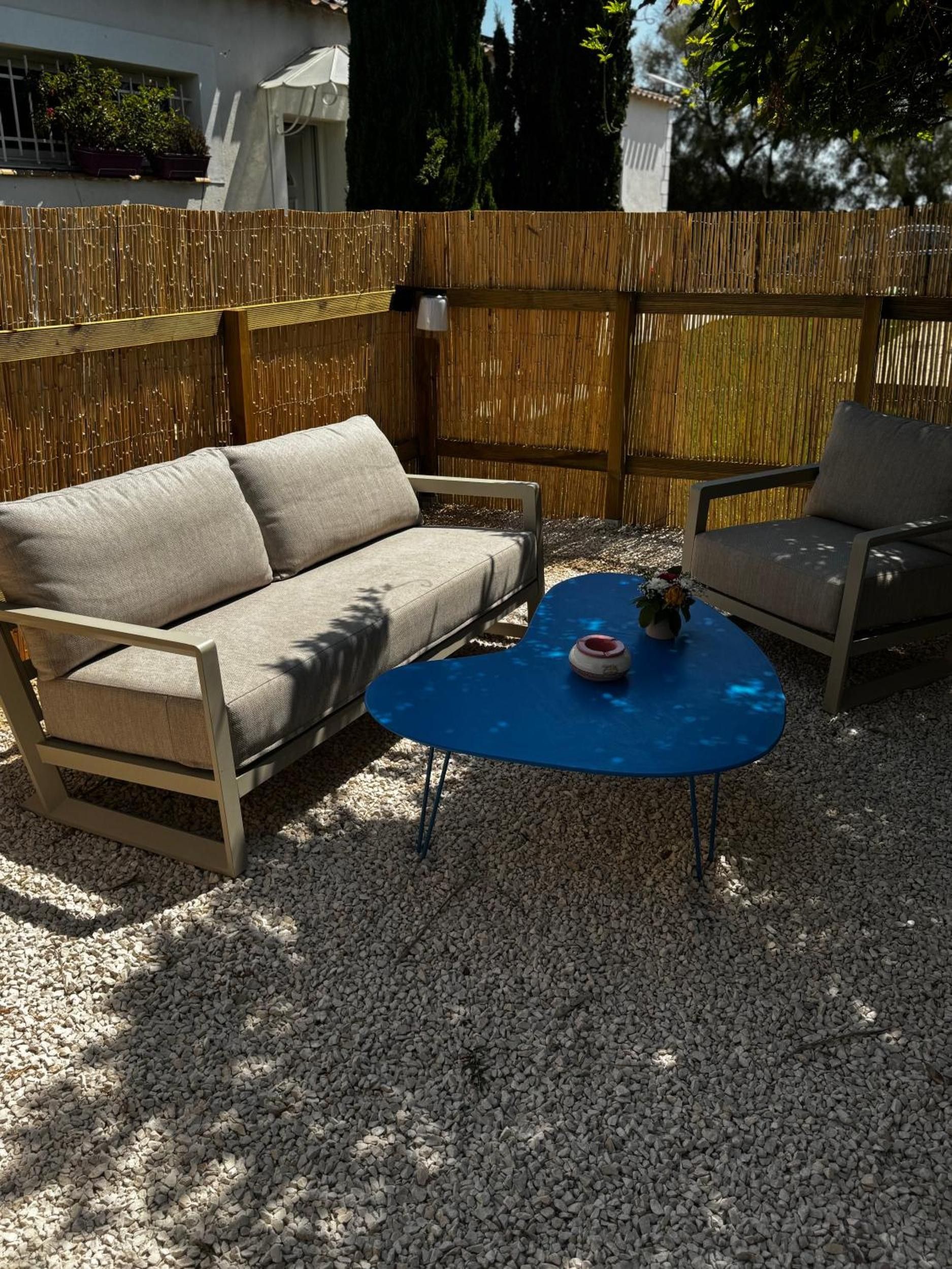 Zona esterna con divano e poltrone, un tavolino e un oggetto decorativo.