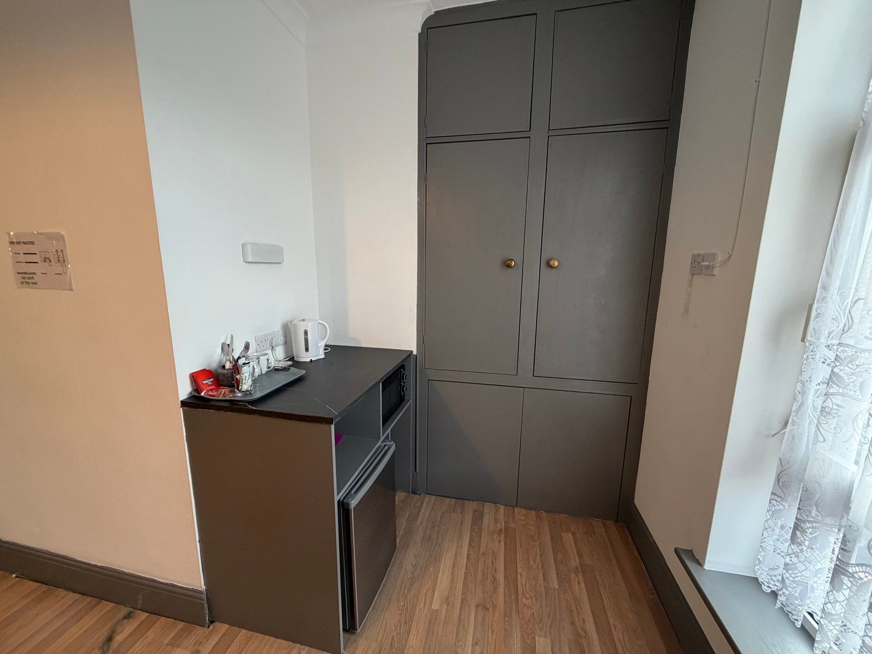 A compact kitchenette with a built-in oven and a small countertop.