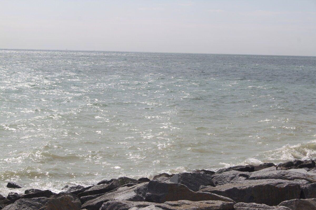 A rocky shoreline with waves crashing onto the rocks.