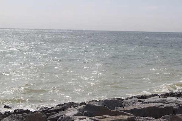 A rocky shoreline with waves crashing onto the rocks.