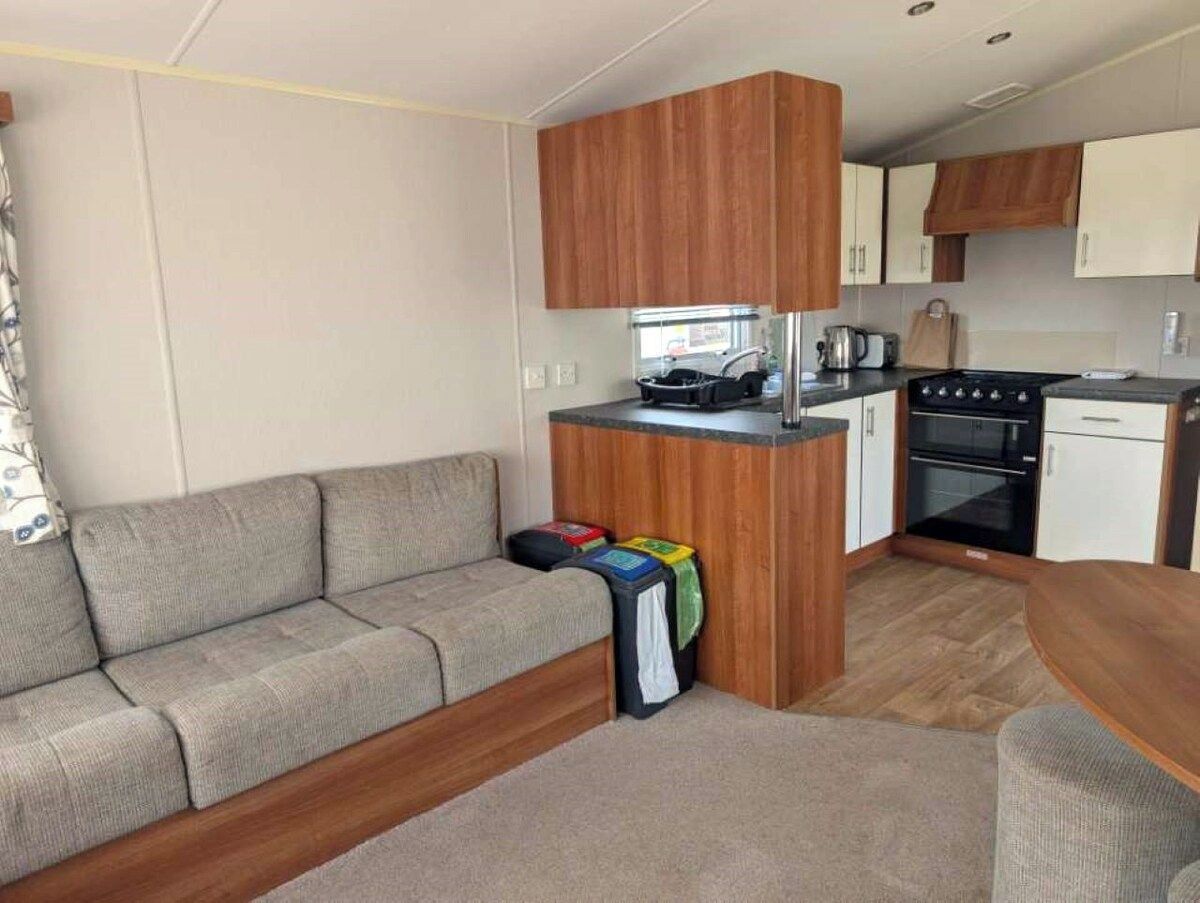 A compact kitchenette with a stove, oven, and sink.