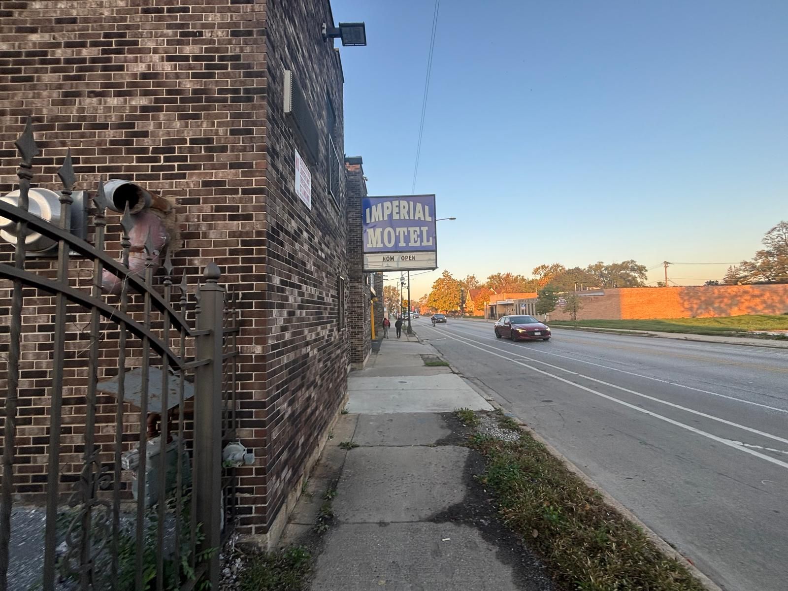 A brick building with a sign for Imperial Motel.