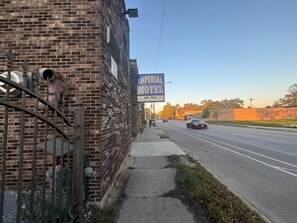 A brick building with a sign for Imperial Motel.